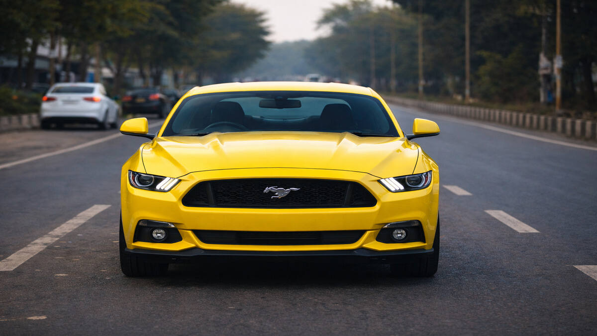 Front view of Ford Mustang in Triple Yellow Tri-Coat parked on an Indian road