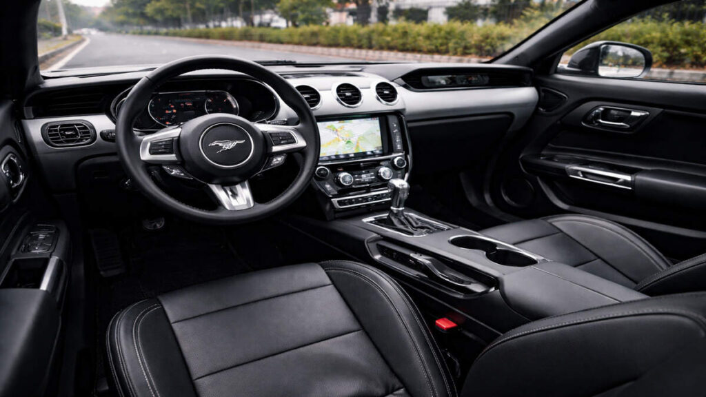 Interior cabin of Ford Mustang with black leather seats and dashboard
