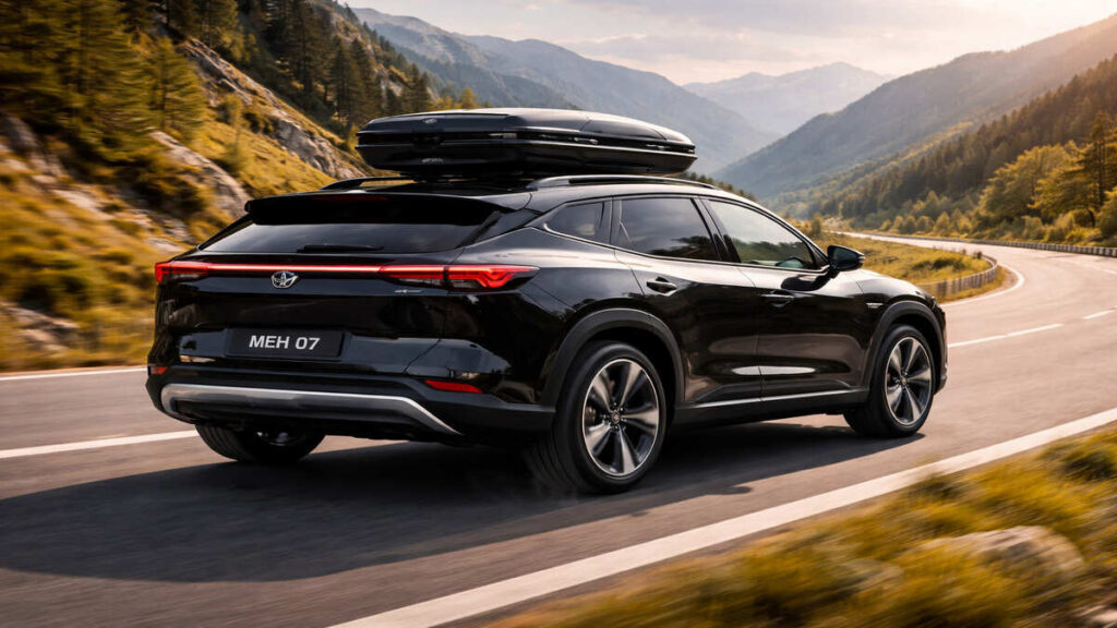 Mahindra BE 07 black electric SUV touring on mountain highway rear angle