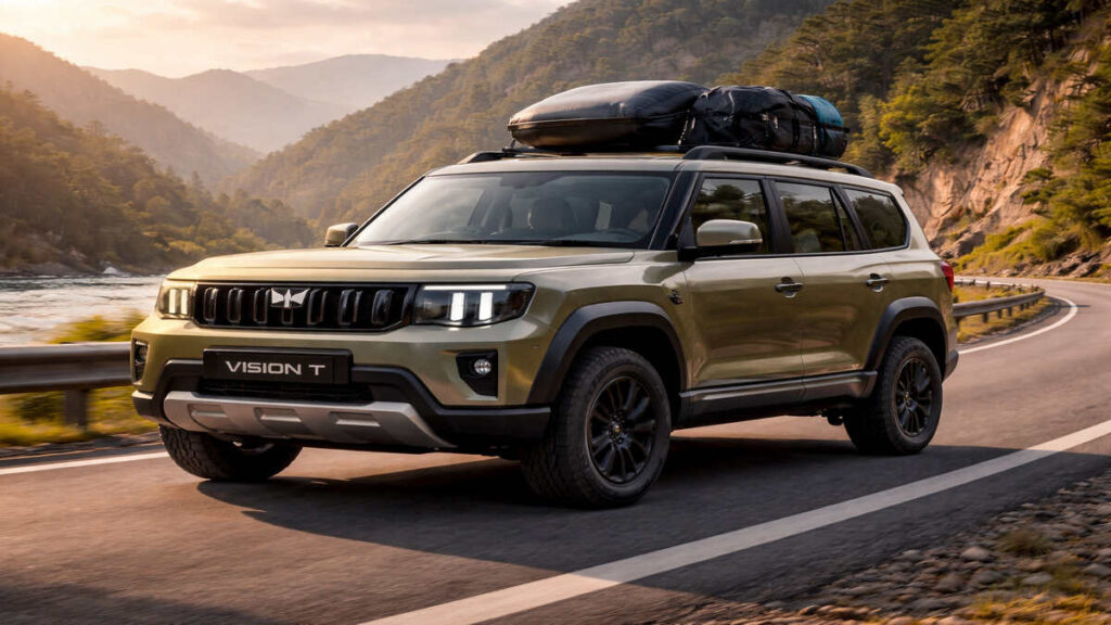 Mahindra Vision T in olive green touring on a mountain road with roof luggage
