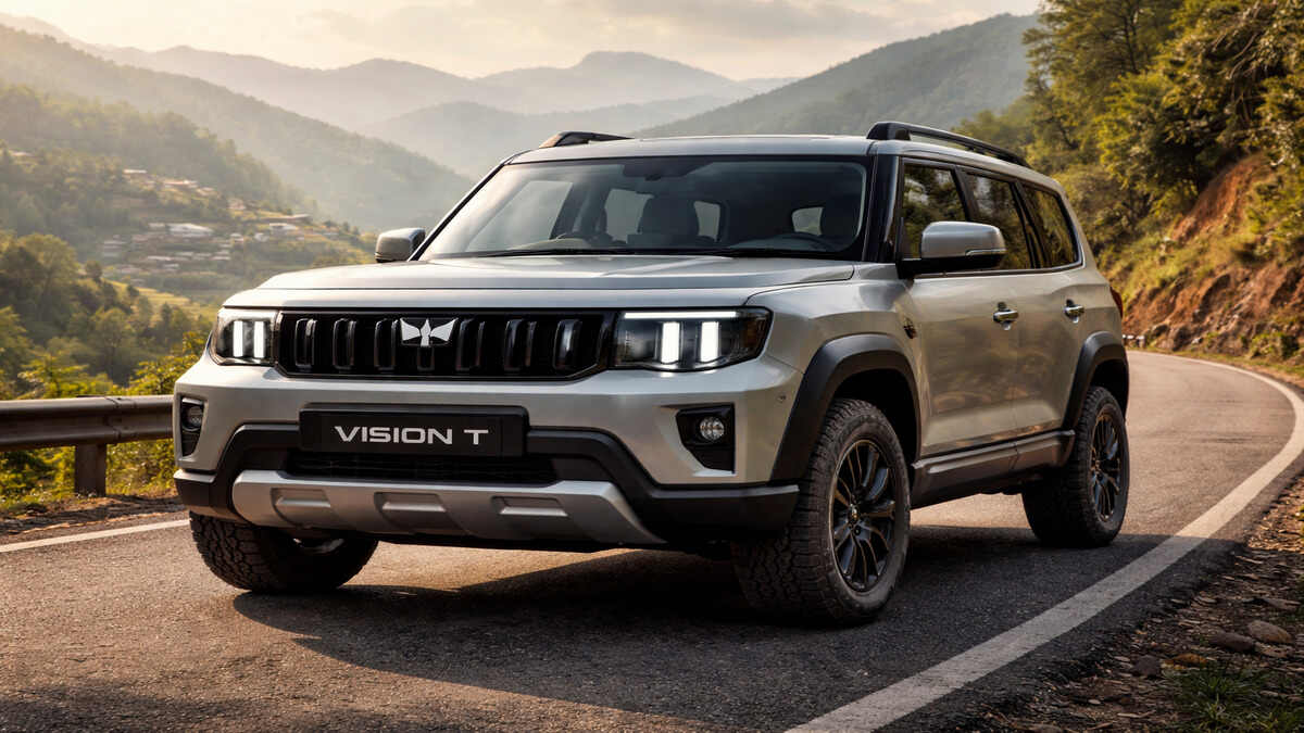 Mahindra Vision T in silver color on an Indian hillside road, realistic 16:9