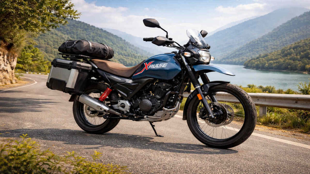 Hero Xpulse 160 in blue touring setup parked on a mountain road in India, 16:9 realistic shot.