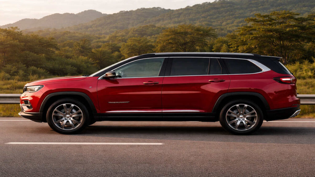 Velvet Red Jeep Meridian side profile on road