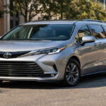 Toyota Sienna family minivan parked on a clean city street, front-angle view in natural daylight.