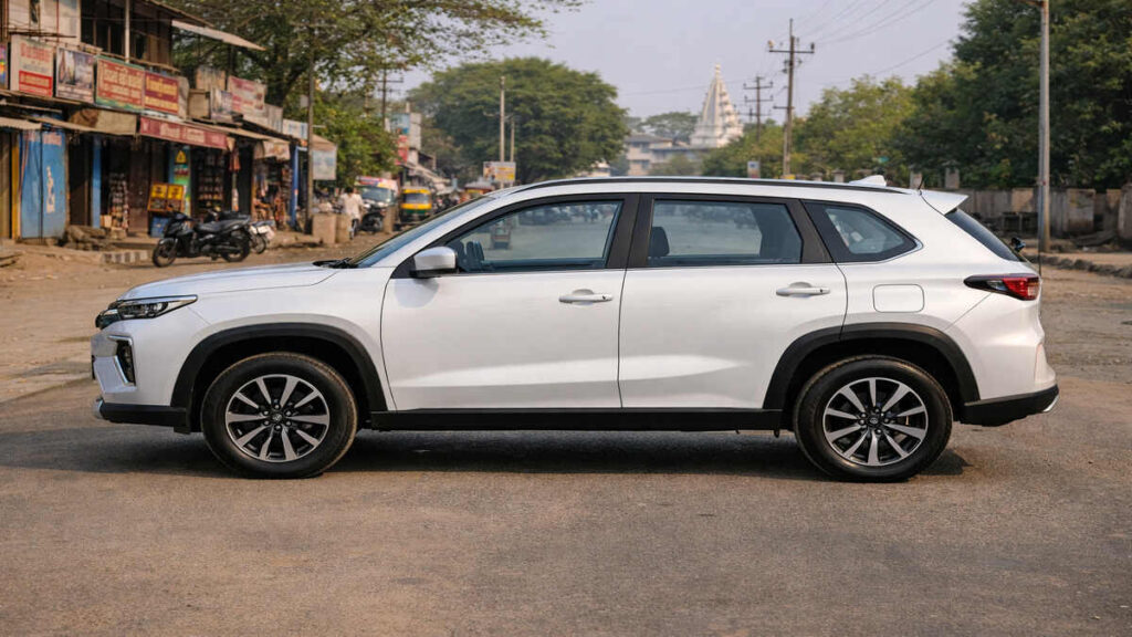 White Toyota Urban Cruiser Hyryder side profile parked on an Indian town road